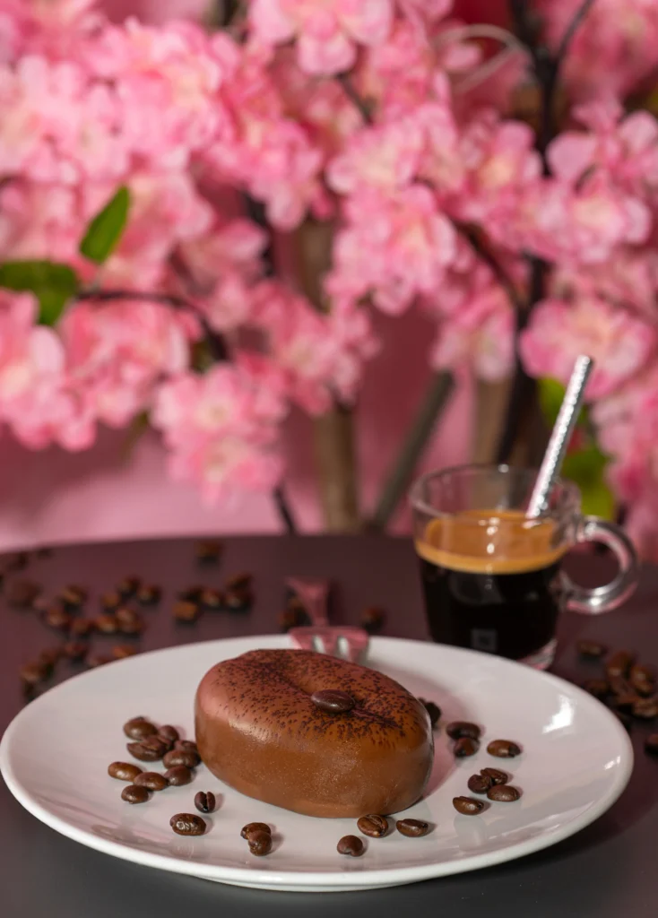Dessert au chocolat accompagné d’un café dans un décor fleuri